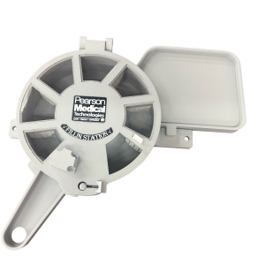 A gray plastic Fillin Station medication dispenser with circular slots and an open compartment, viewed from above on a white background.