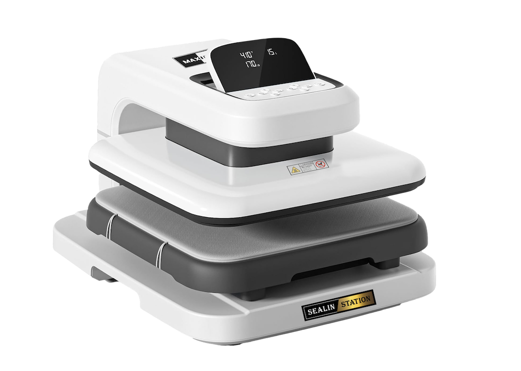 A white and gray heat press machine with a digital control panel on top, labelled SEALIN STATION. The machine features a flat pressing surface and buttons for operation.
