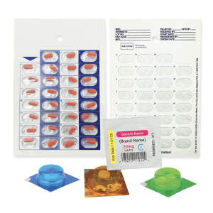 A medication blister pack with red tablets, an empty clear blister card, and three colored sample blisters, along with a label displaying medication information, arranged on a white background.